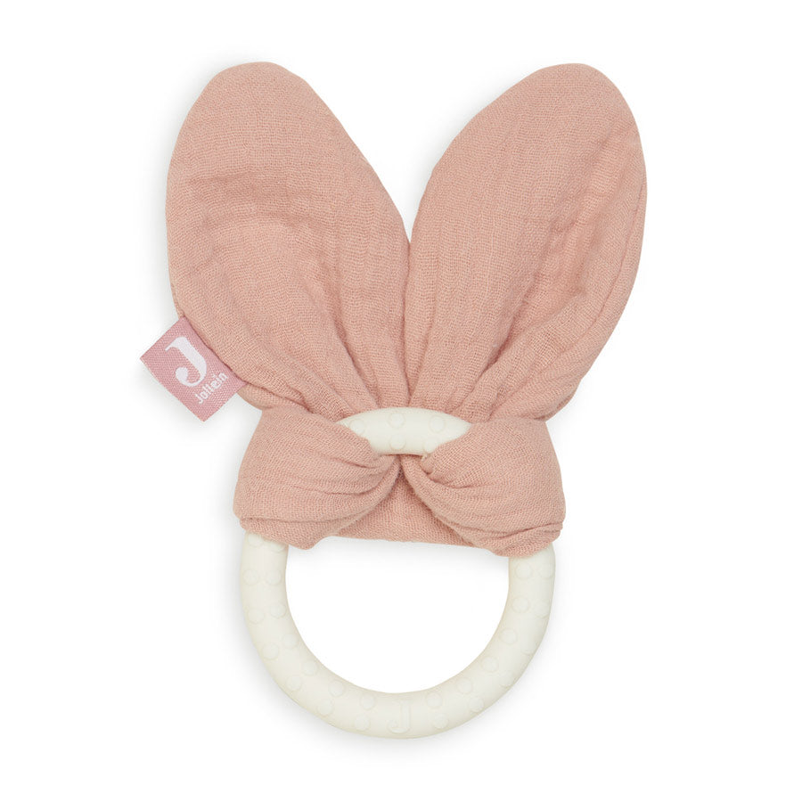 Der Silikonring in der Farbe rosa hat einen weißen Silikonbeiring und Hasenohren aus Musselinstoff, die um den Silikonring gebunden sind.