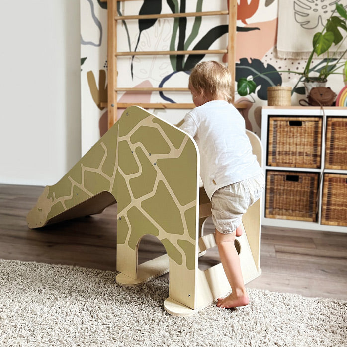 Kind klettert auf der Giraffen-Rutsche von Small Foot im Kinderzimmer