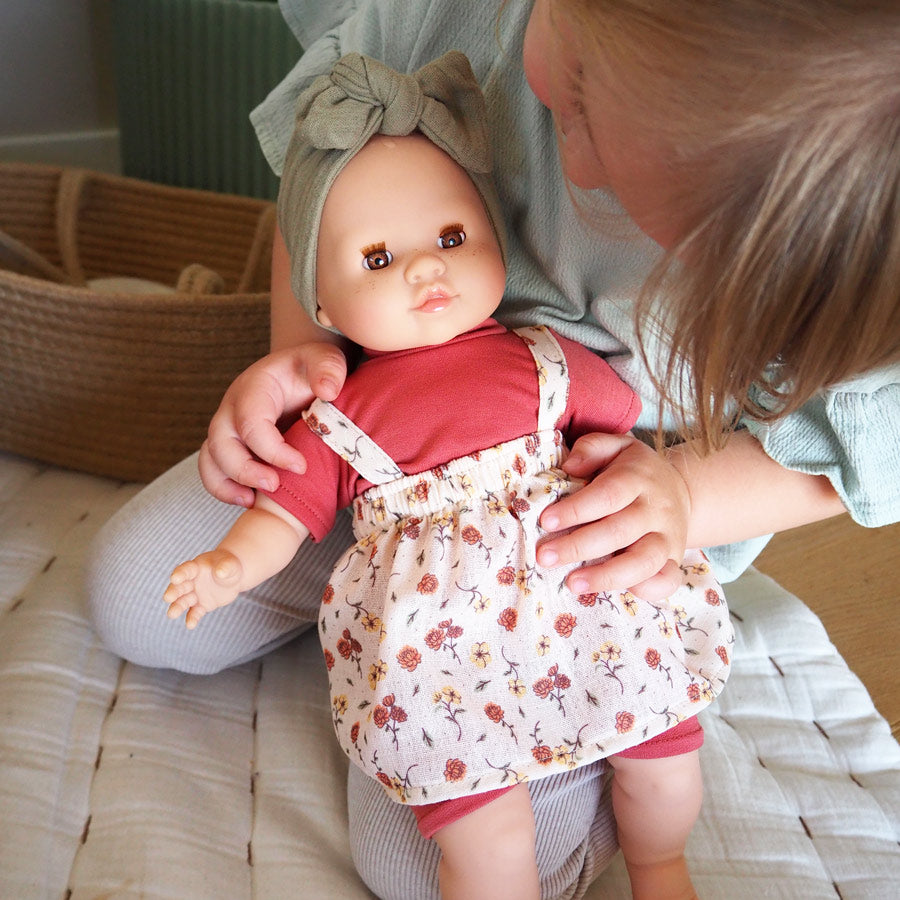 Mädchen spielt mit der Puppe Julia von Paola Reina