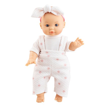 Die Puppe von Paola Reina hat blaue Augen und trägt ein rosafarbenes Puppenoutfit mit Schleife auf dem Kopf.